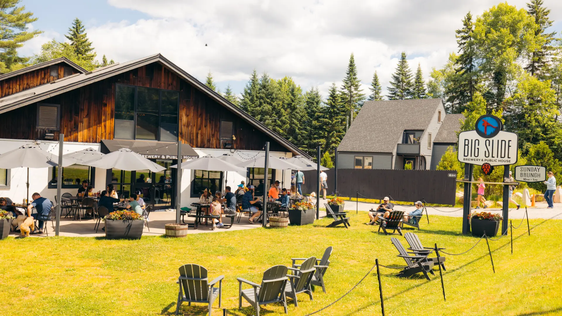 A brewery in summer with lawn and games.