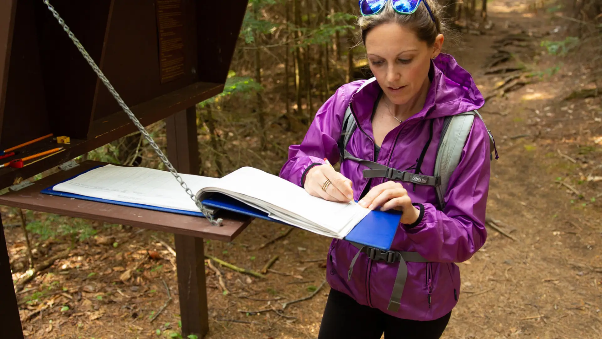 A hiker registers at trailhead