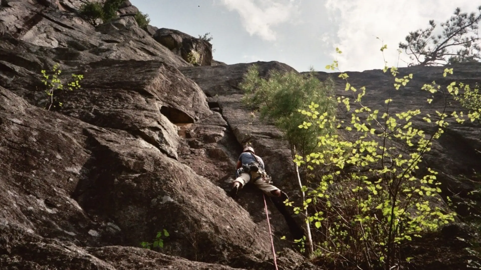 Someone climbing up a rock climbing roiute