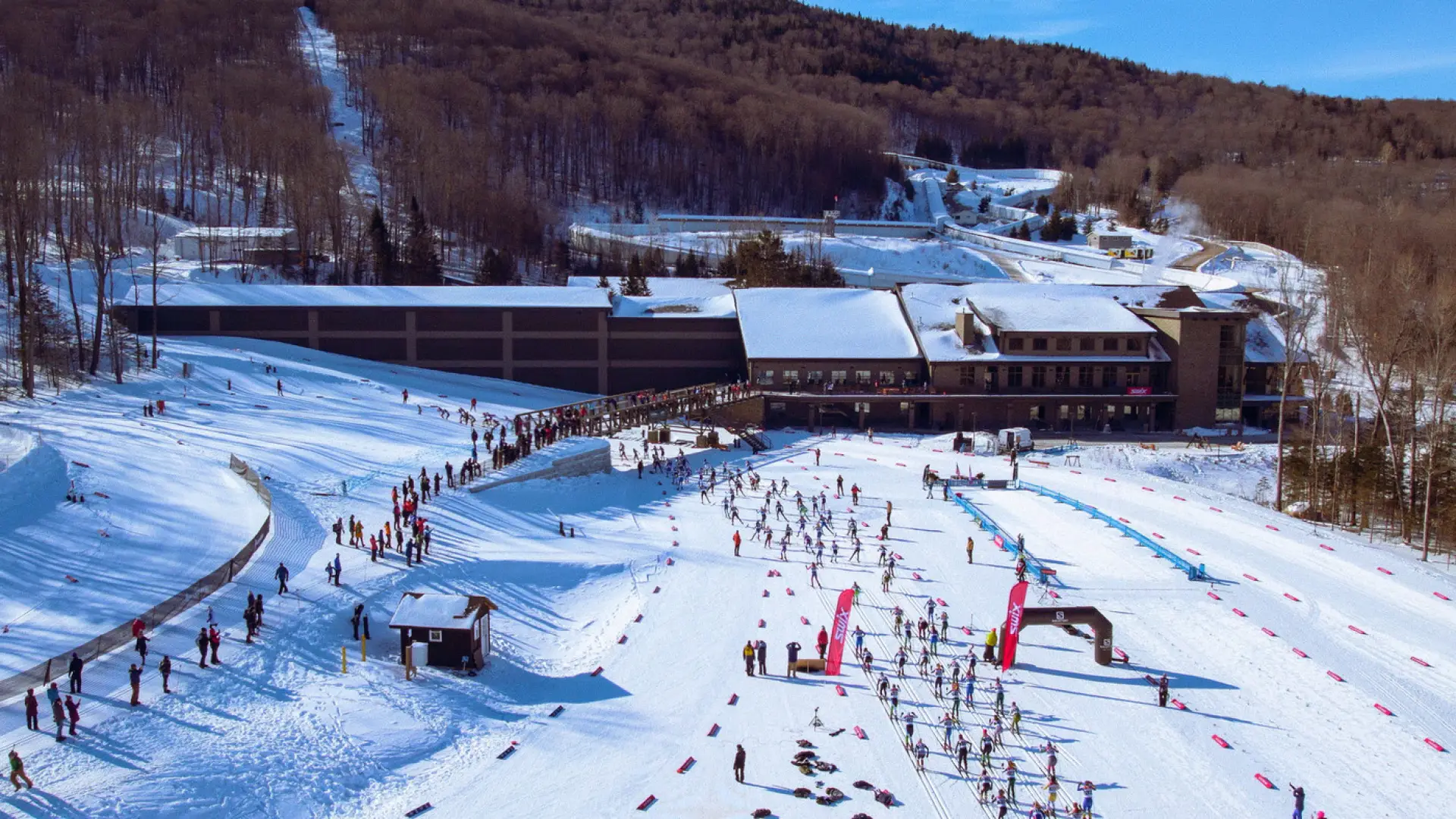 The image shows a snowy landscape with a ski resort in the background. 