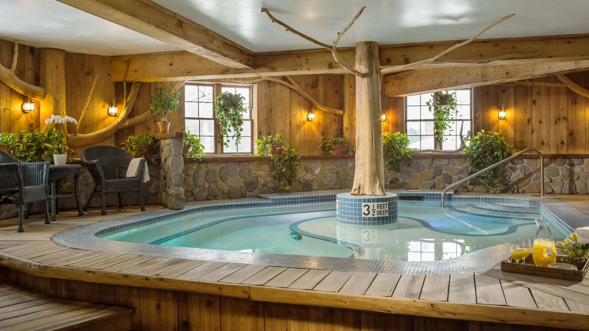 A warm indoor jacuzzi awaits you with lush foliage surrounding