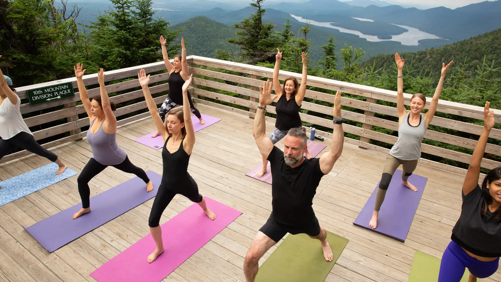 Mountain top yoga on the Little Whiteface observation deck looking over Lake Placid