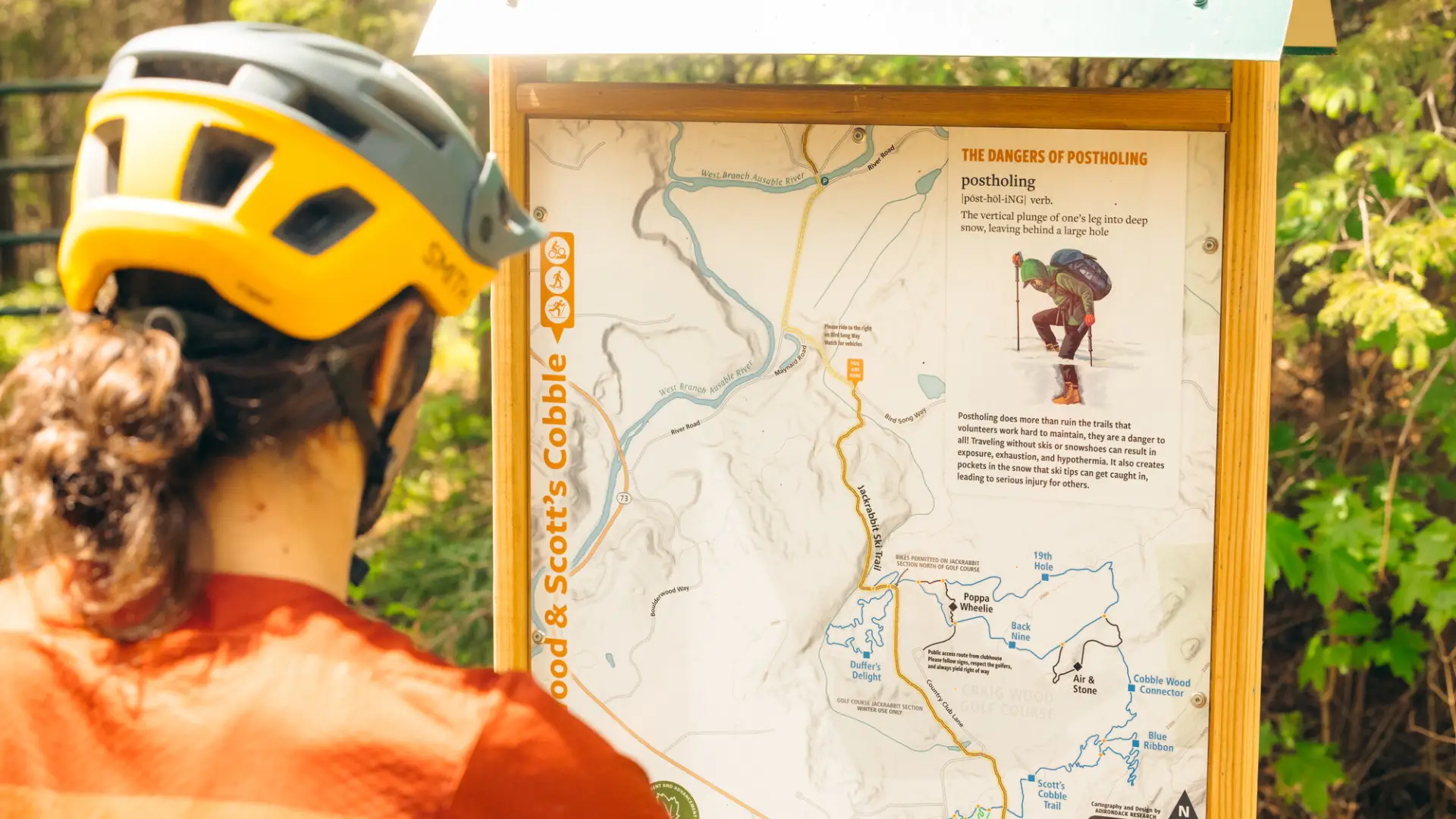 A mountain biker looks at a map