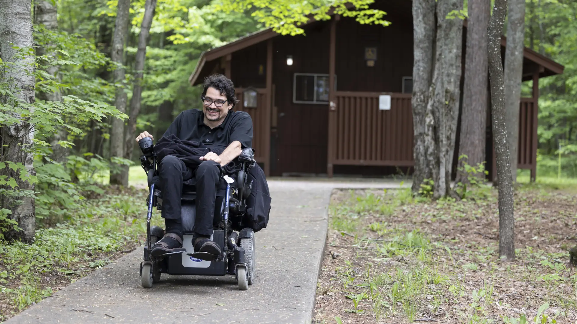 A man in a wheelchair in a campground