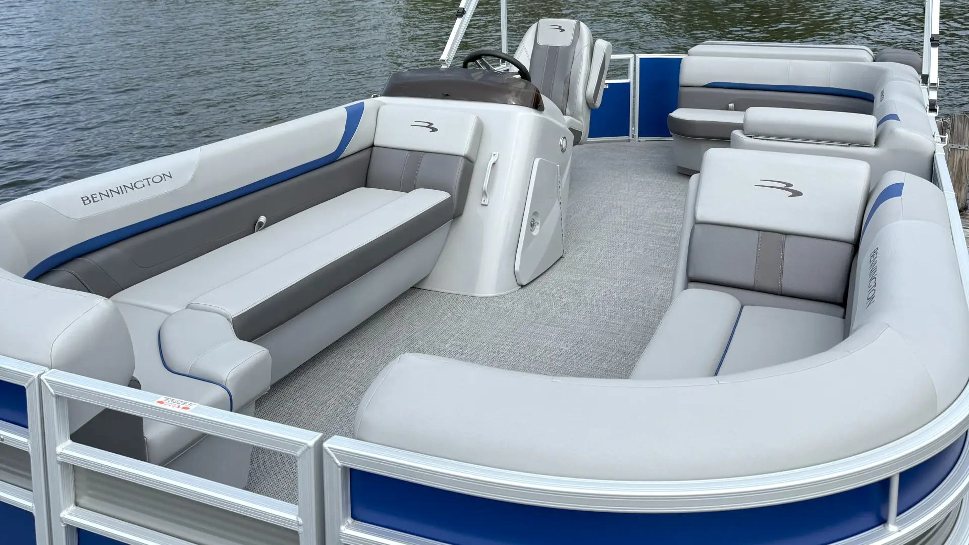 A blue and white pontoon boat from the front