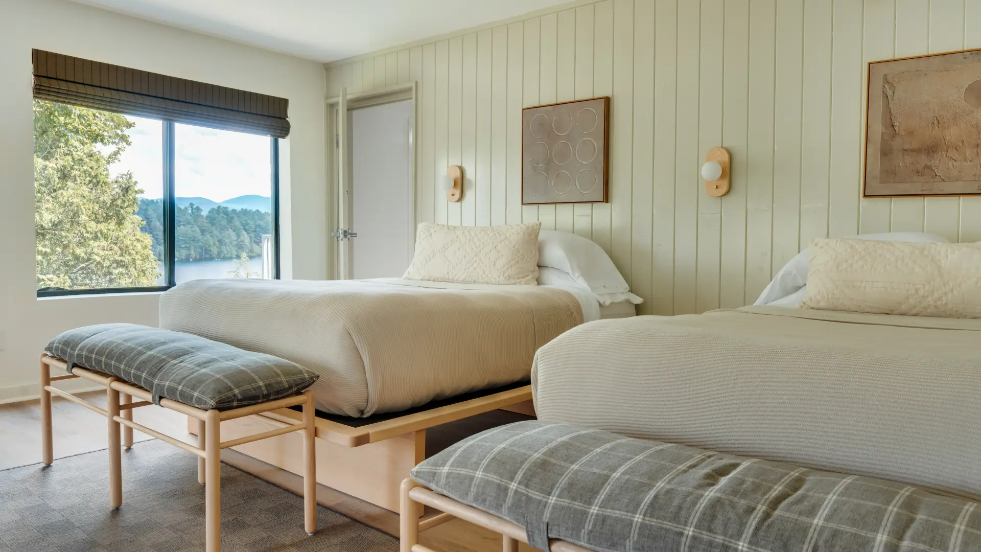 A two queen room at Laurel Lake Placid with mint walls, light wood and view of the mountains