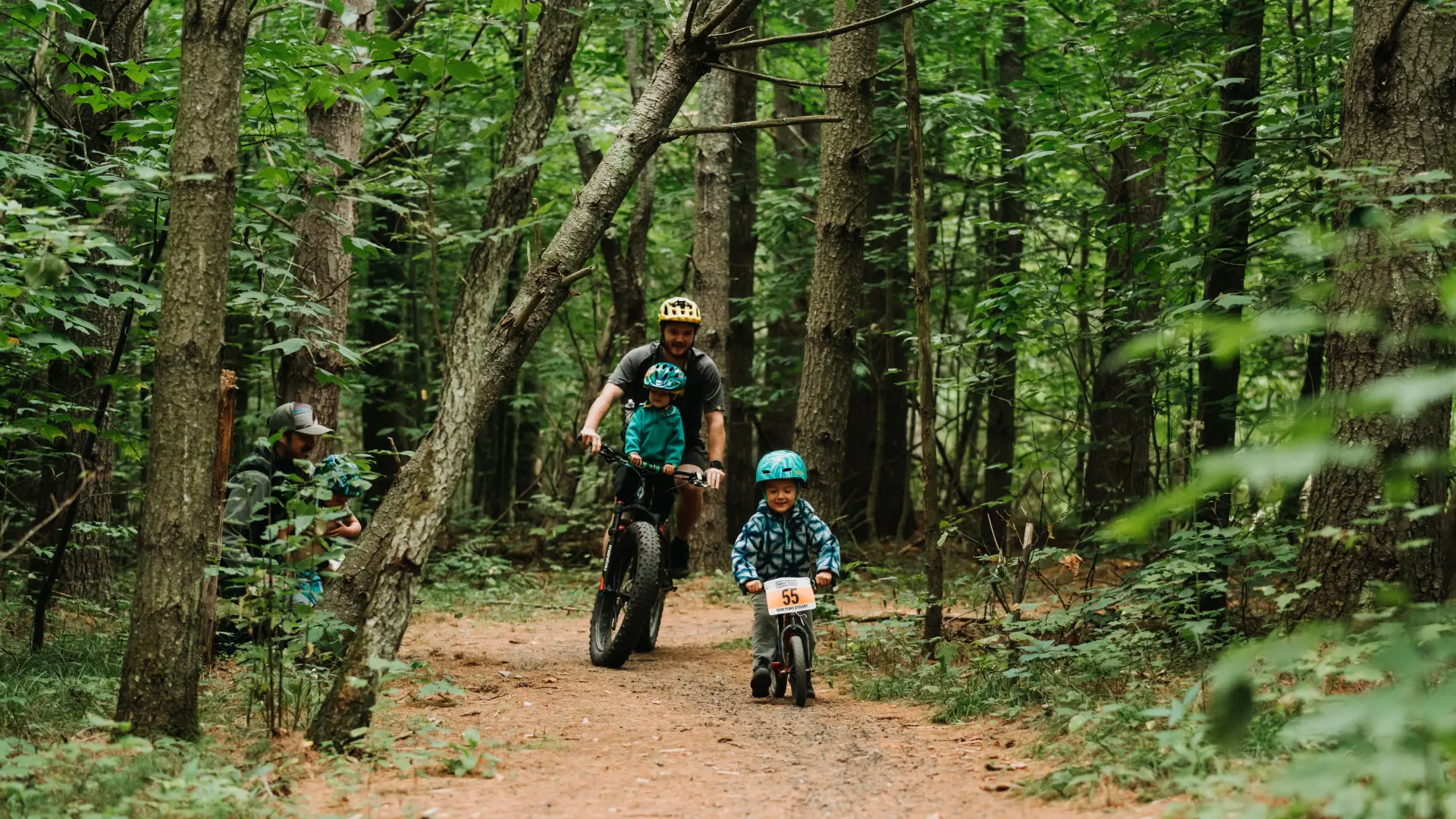 A father and his two kids mountain biking