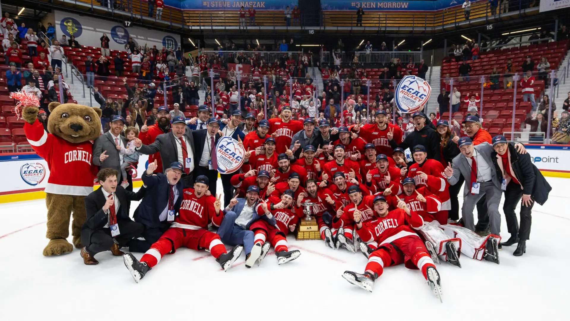 The image captures a close-up of hands reaching out, wearing red hockey gloves. 