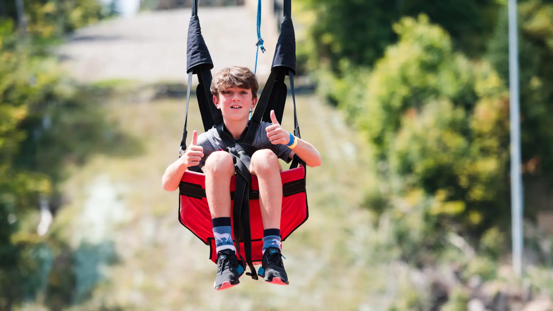 Child give thumbs up fro the zip Line