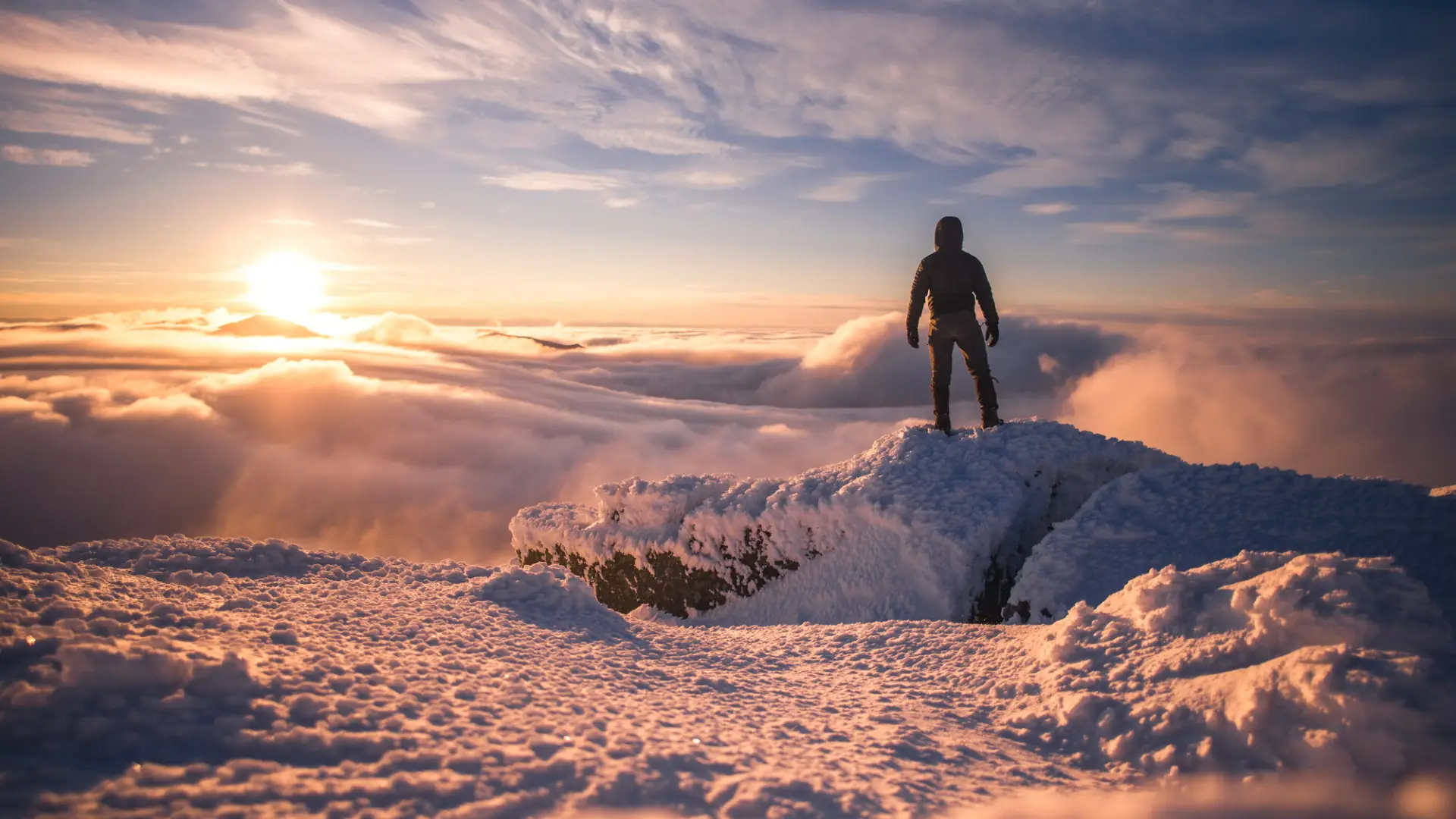 A hiker at a winter summit.