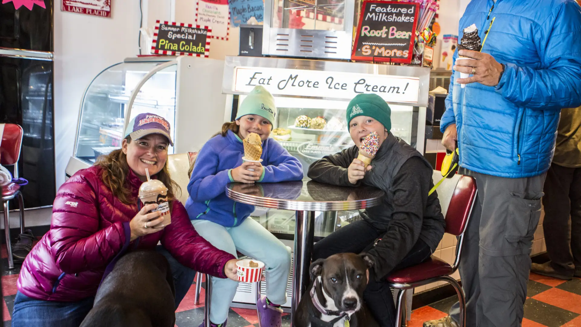 family of four enjoying different desserts