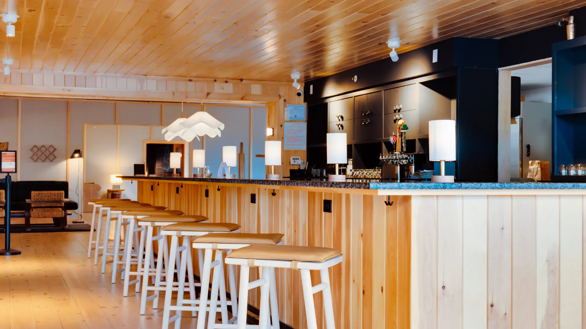 A bright bar space with wood and dark counter