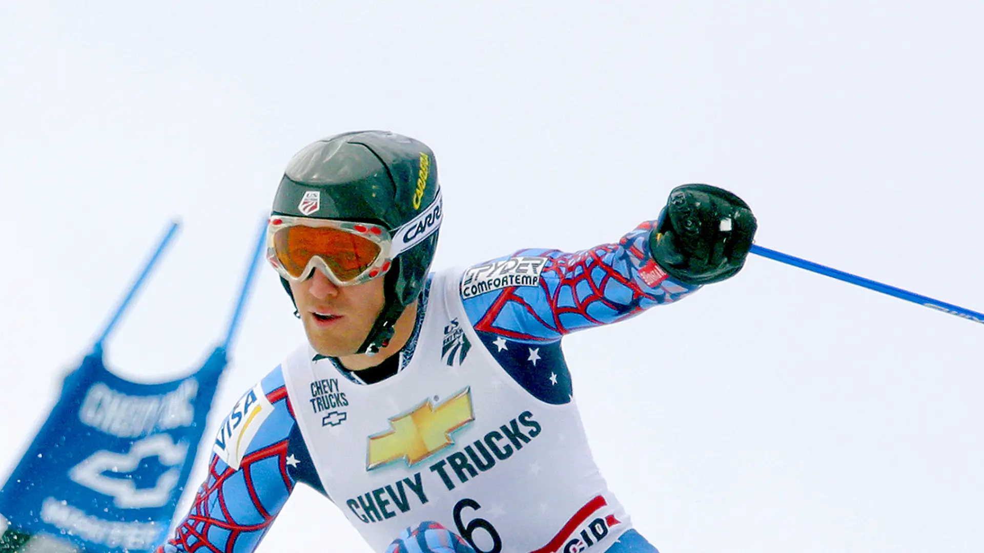 An alpine skier races down a course at a world-class competition.
