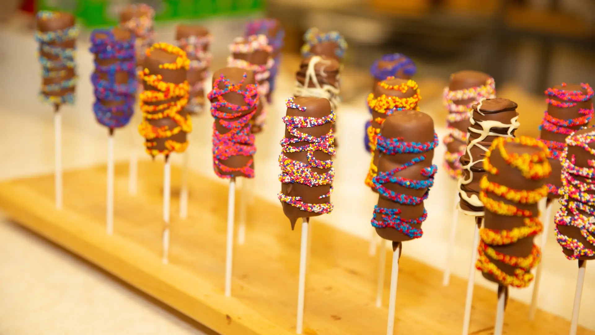 Close up of chocolate covered marshmallow lollipops.