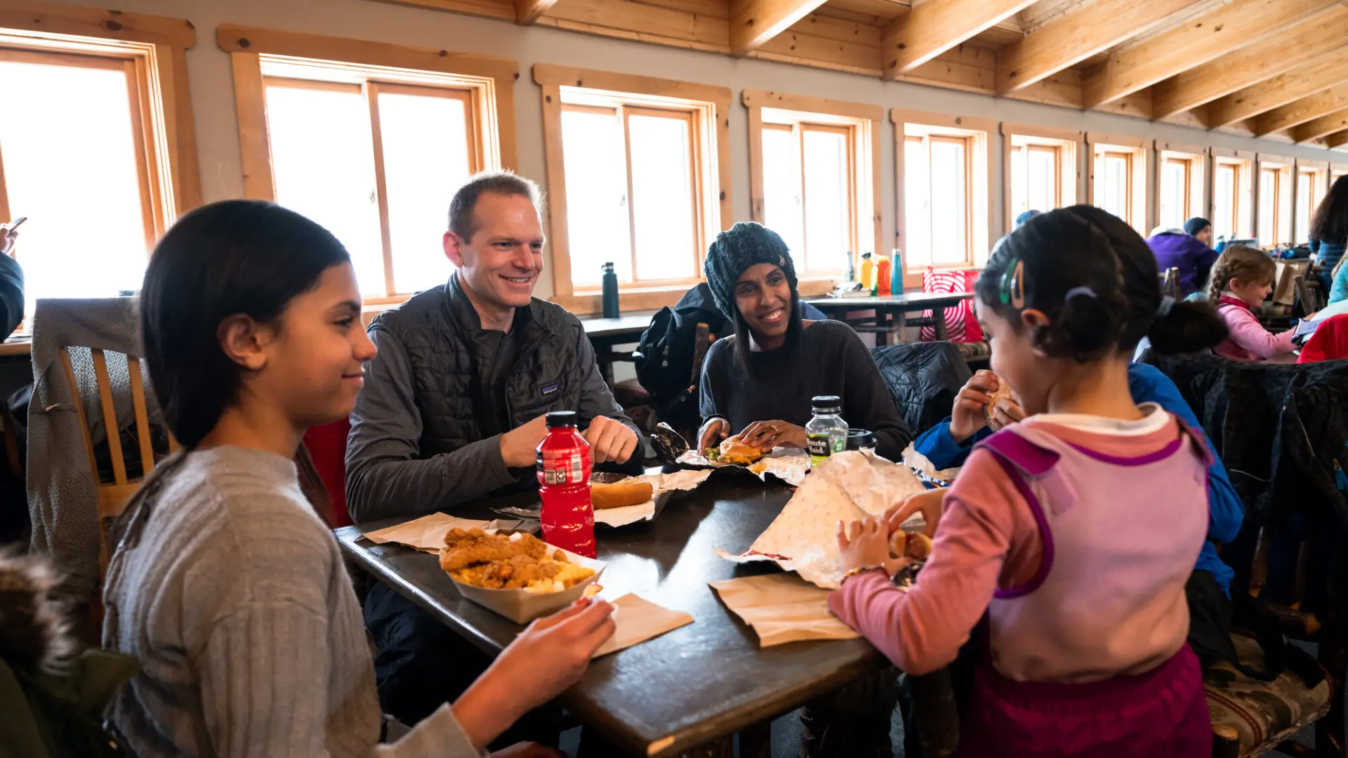 A family eats at a ski mountain lodge