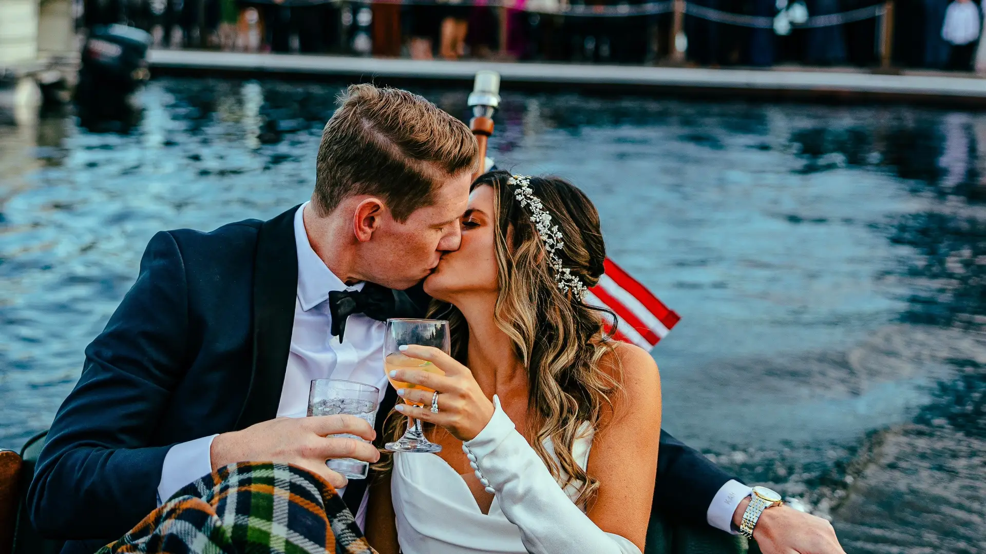 A bride and groom ride into the sunset on a Chris Craft wooded boat