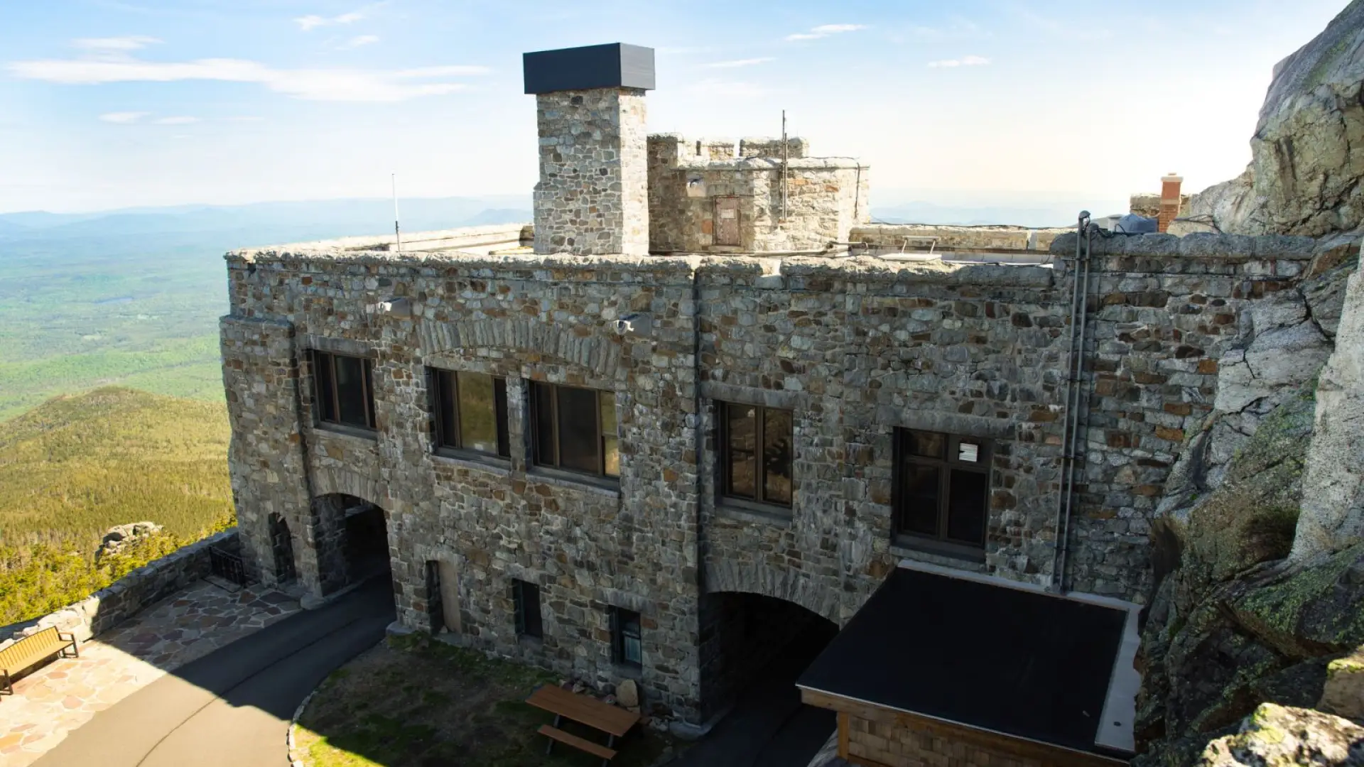 A low drone shot looking down at the side of Whiteface Mountain castle