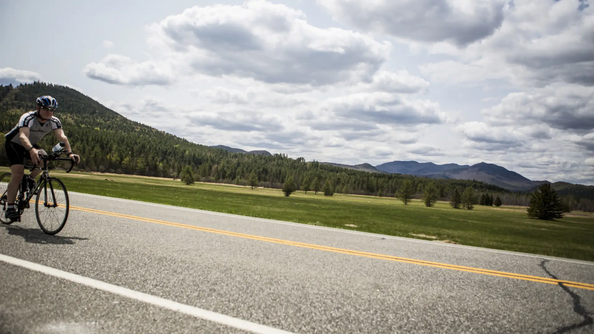A cycler glides down a road