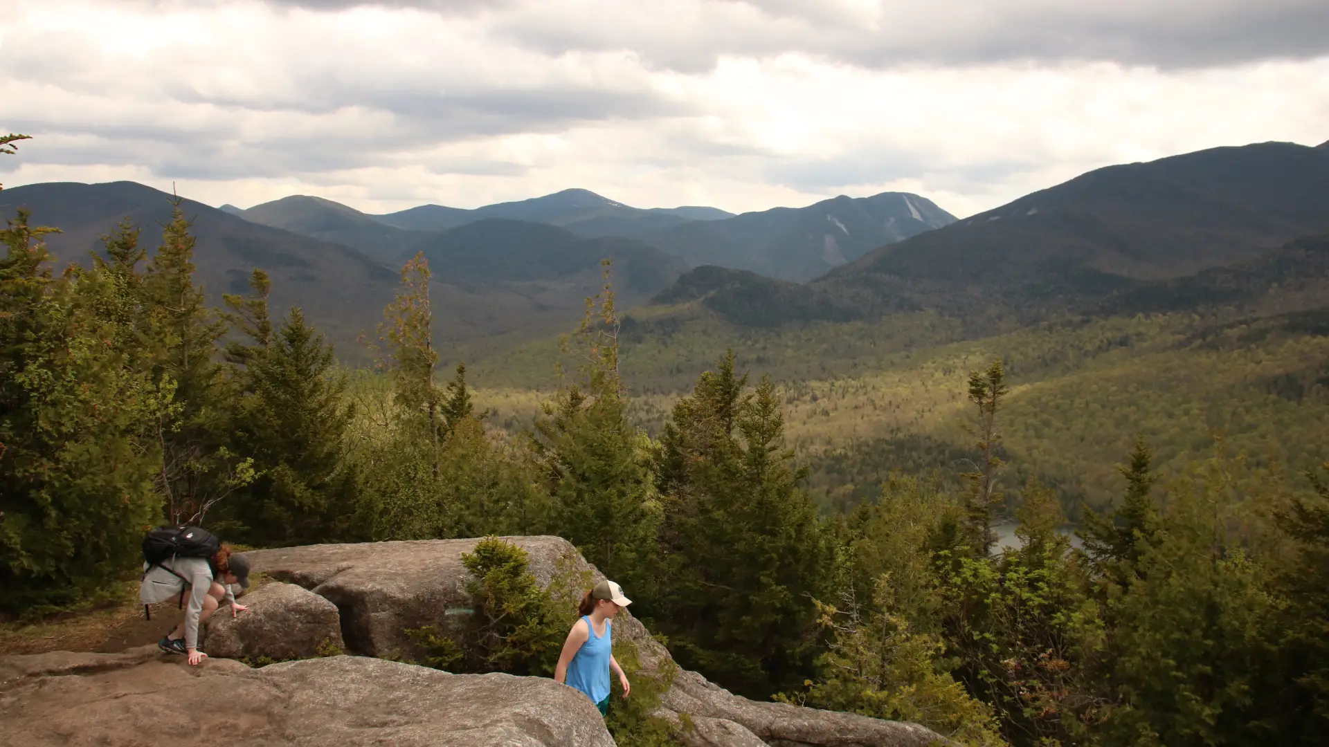 A family hiking a rock summit