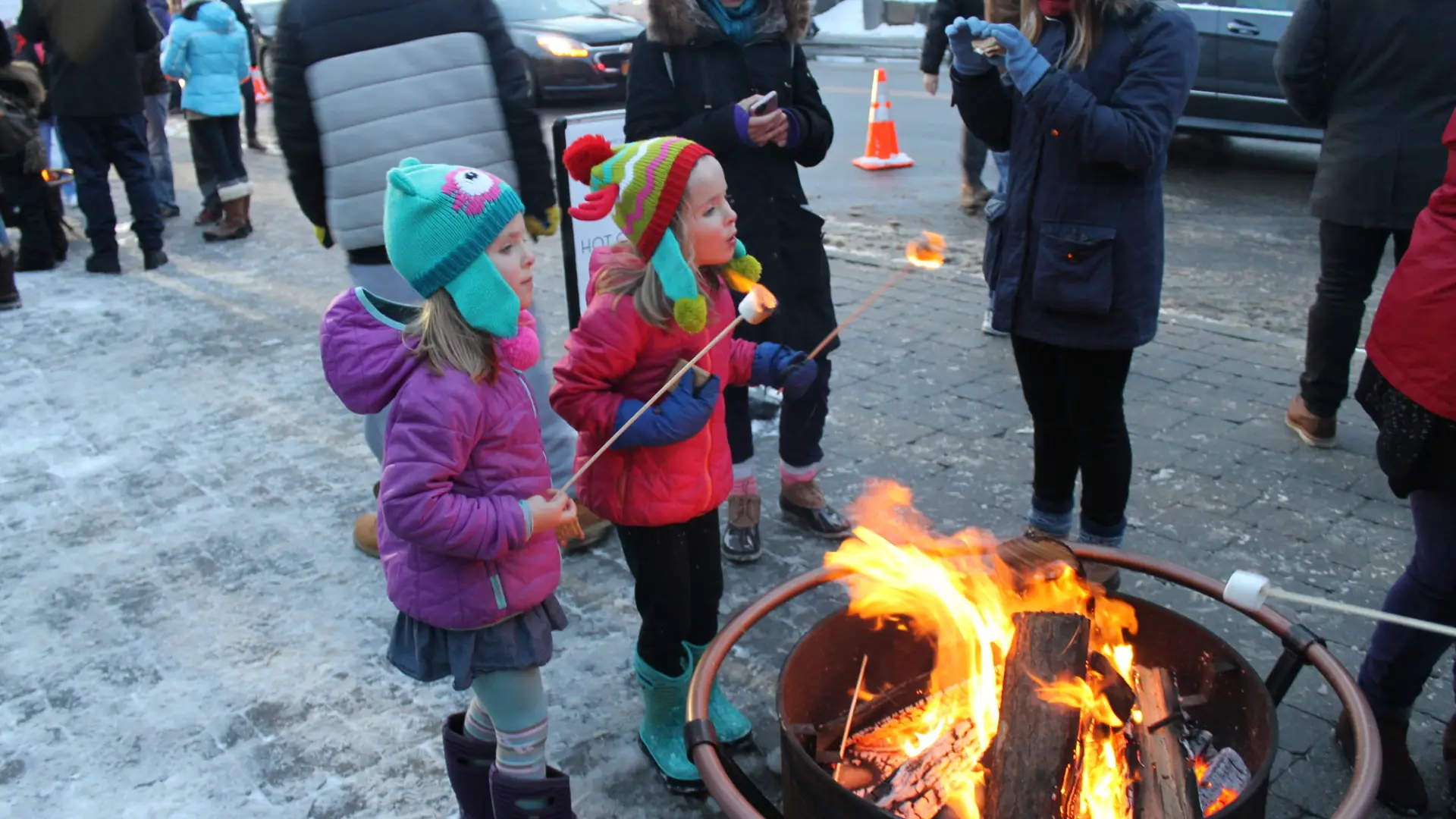 2 children roast marshmallow on Main Street