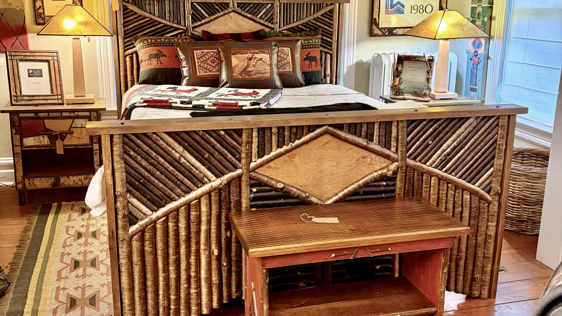 A bed frame decorated with sticks cut and arranged into intricate patterns.