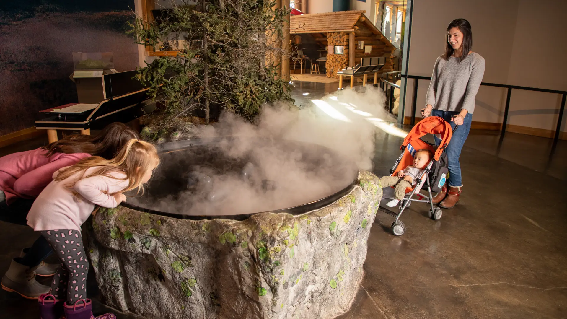 A family explores a foggy exhibit at Tupper Lake's Wild Center