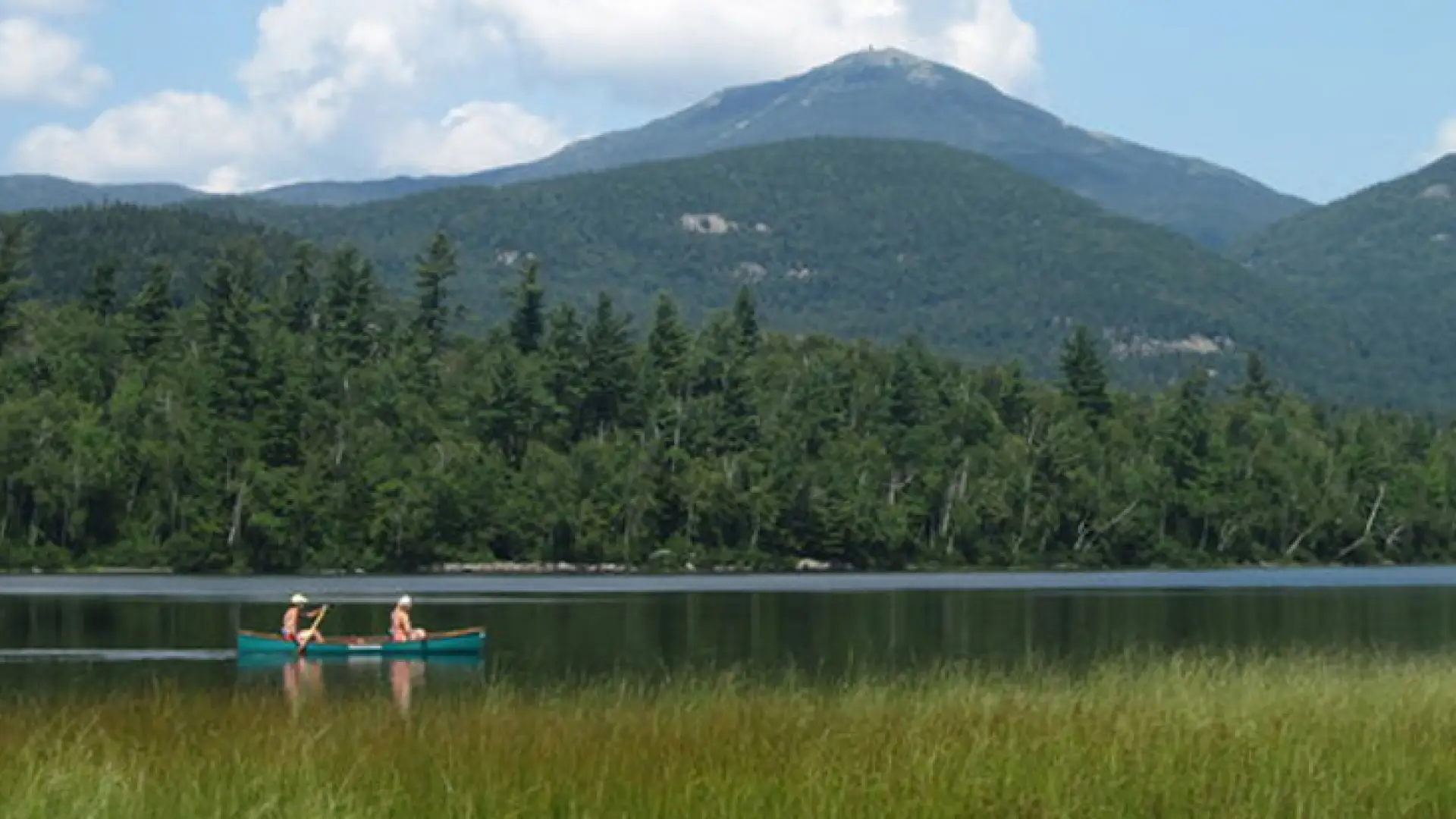 A C2 on a pond with a large mountain in the background