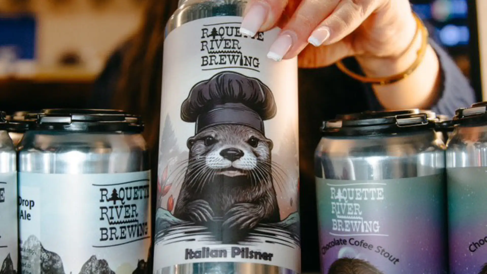A woman restocking the beer fridge with cans