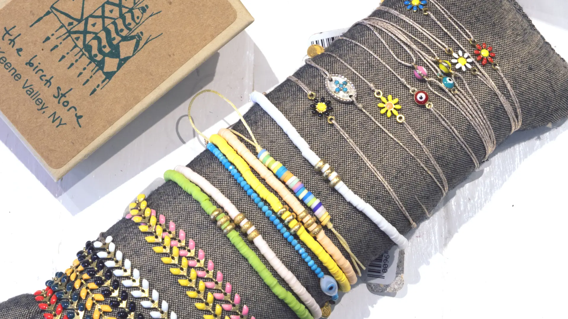 Beaded bracelets in every color next to custom Birch Store boxes