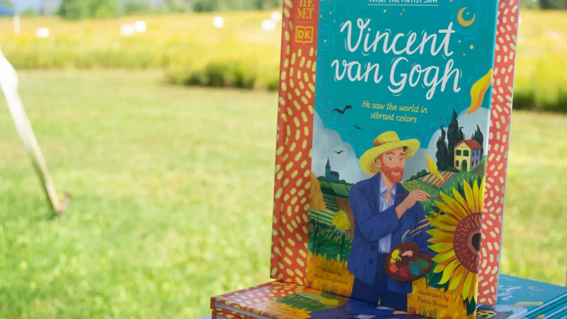 A book about Van Goh on a display stand outside.