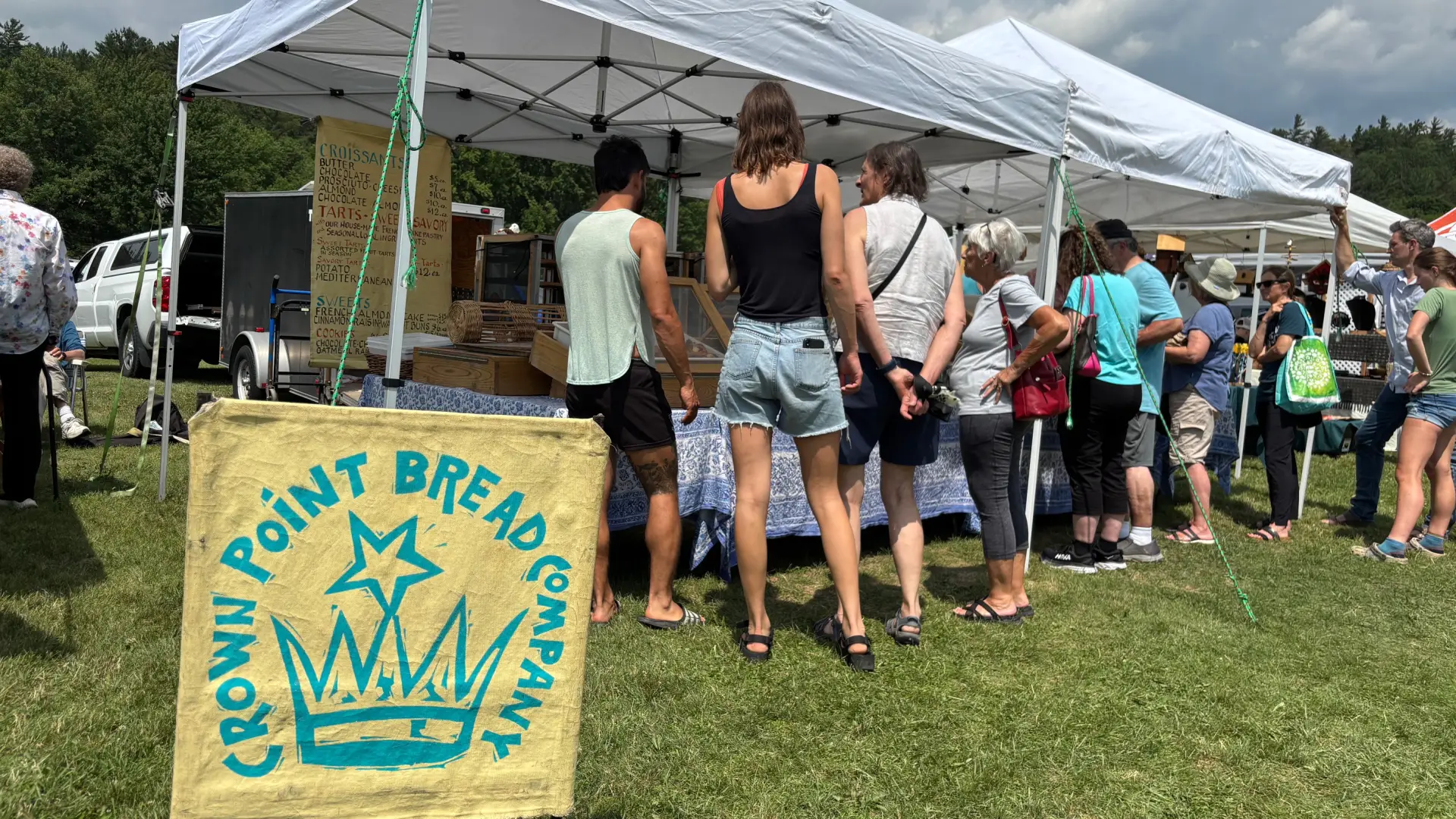 The line of shoppers look into the tent for Crown Point Break Company