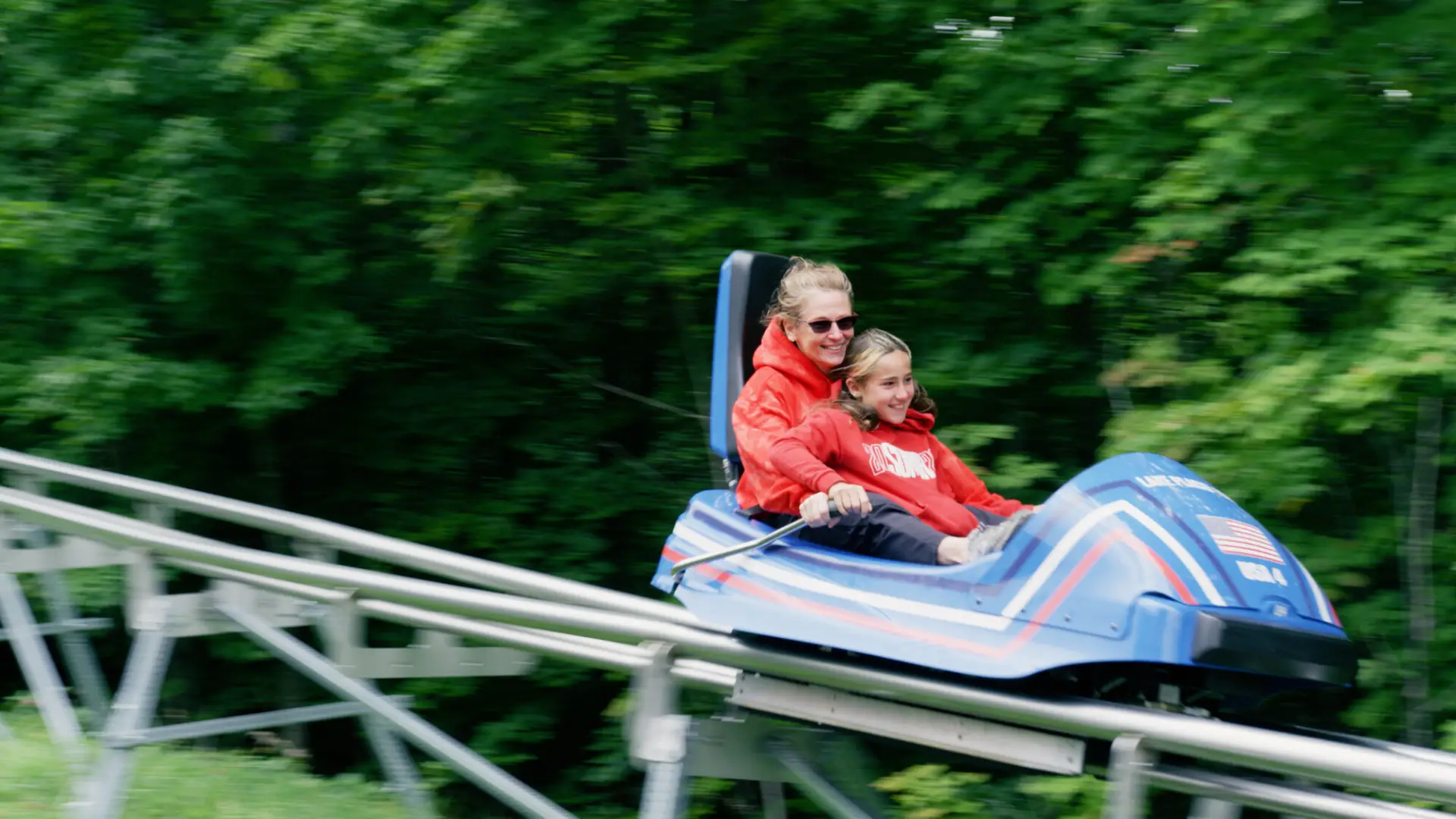 Mother and child ride the Cliffside Coaster