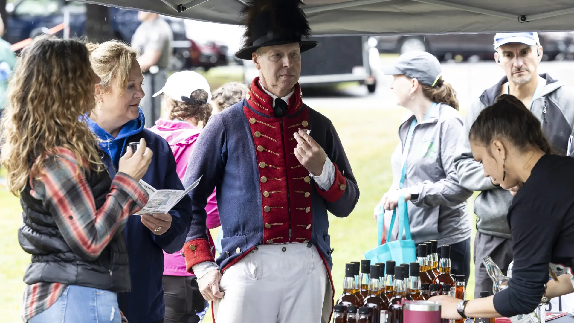 Re-enactor and guests sample whiskey