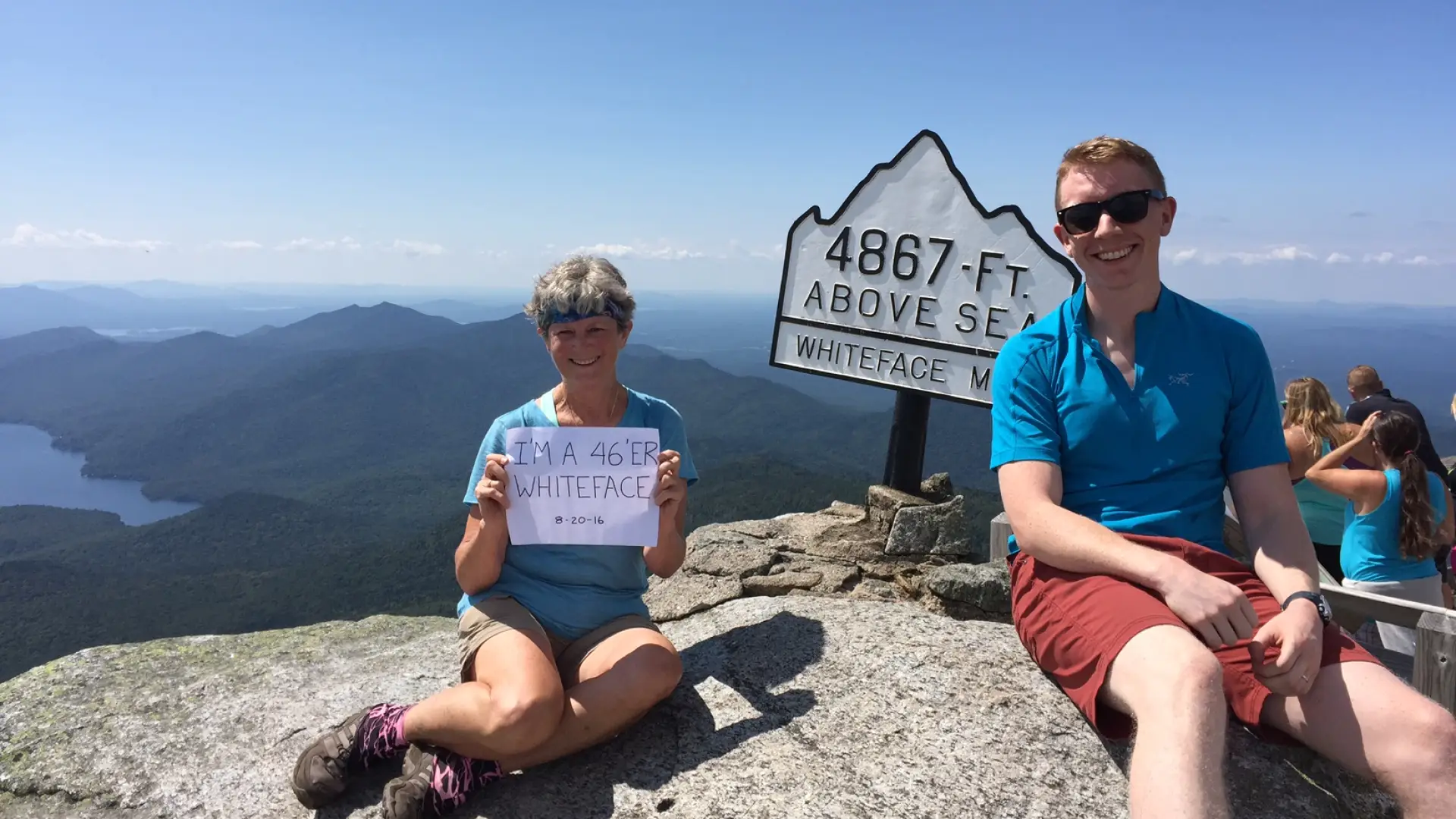 A family sits at the summit of Whiteface Mountain