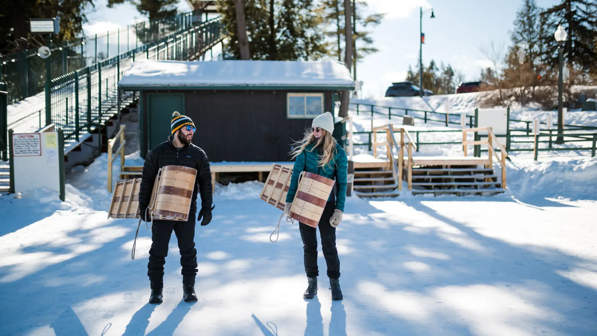 A couple going bobsledding in winter.