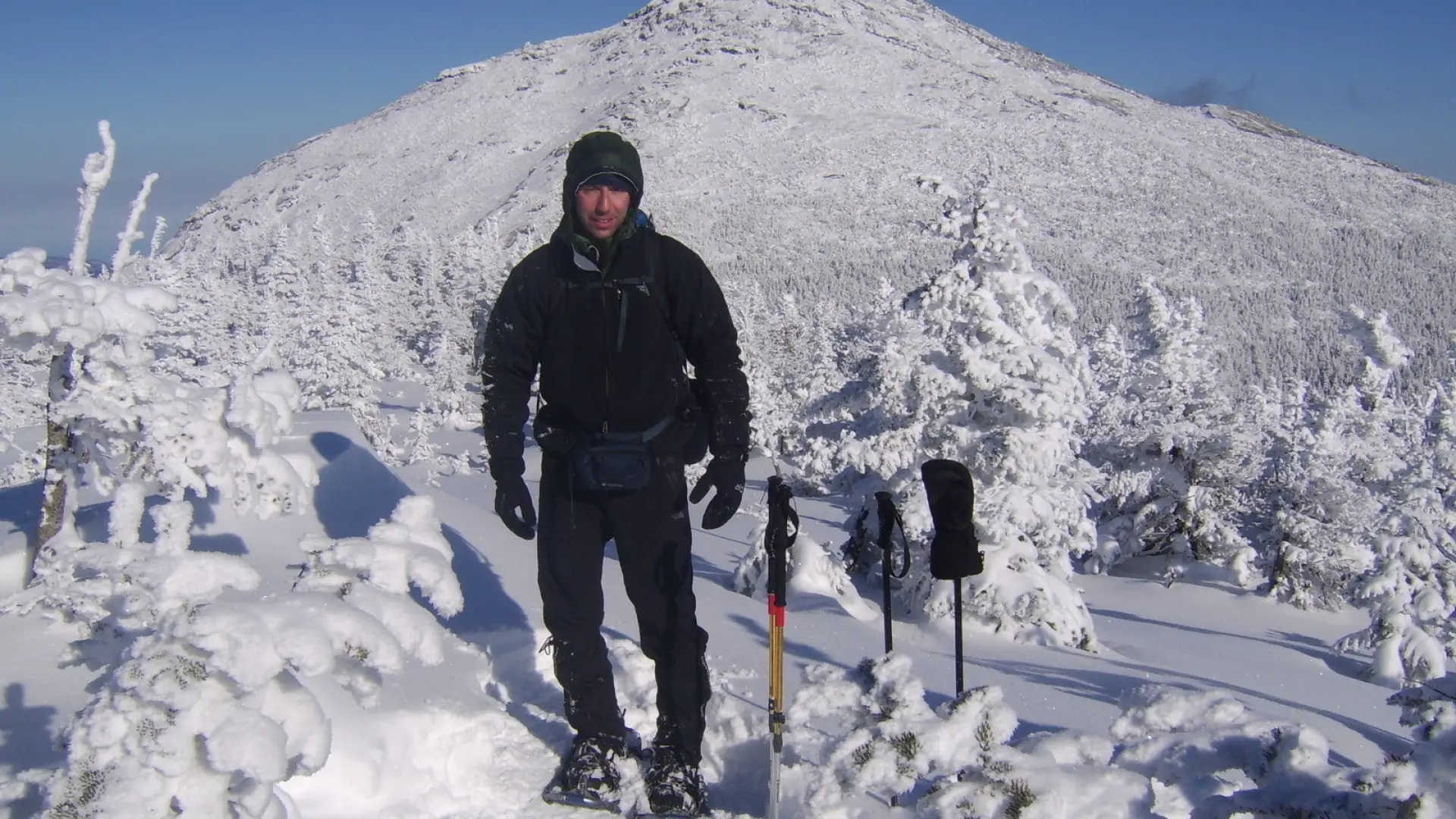 A hiker in the High Peaks in winter. Very snowy conditions.