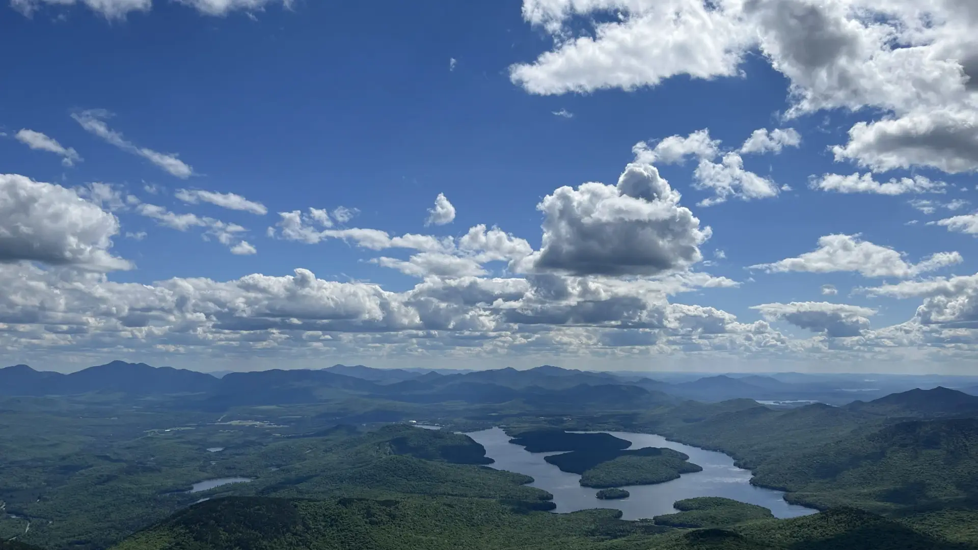 Lake Placid shimmers under puffy white clouds