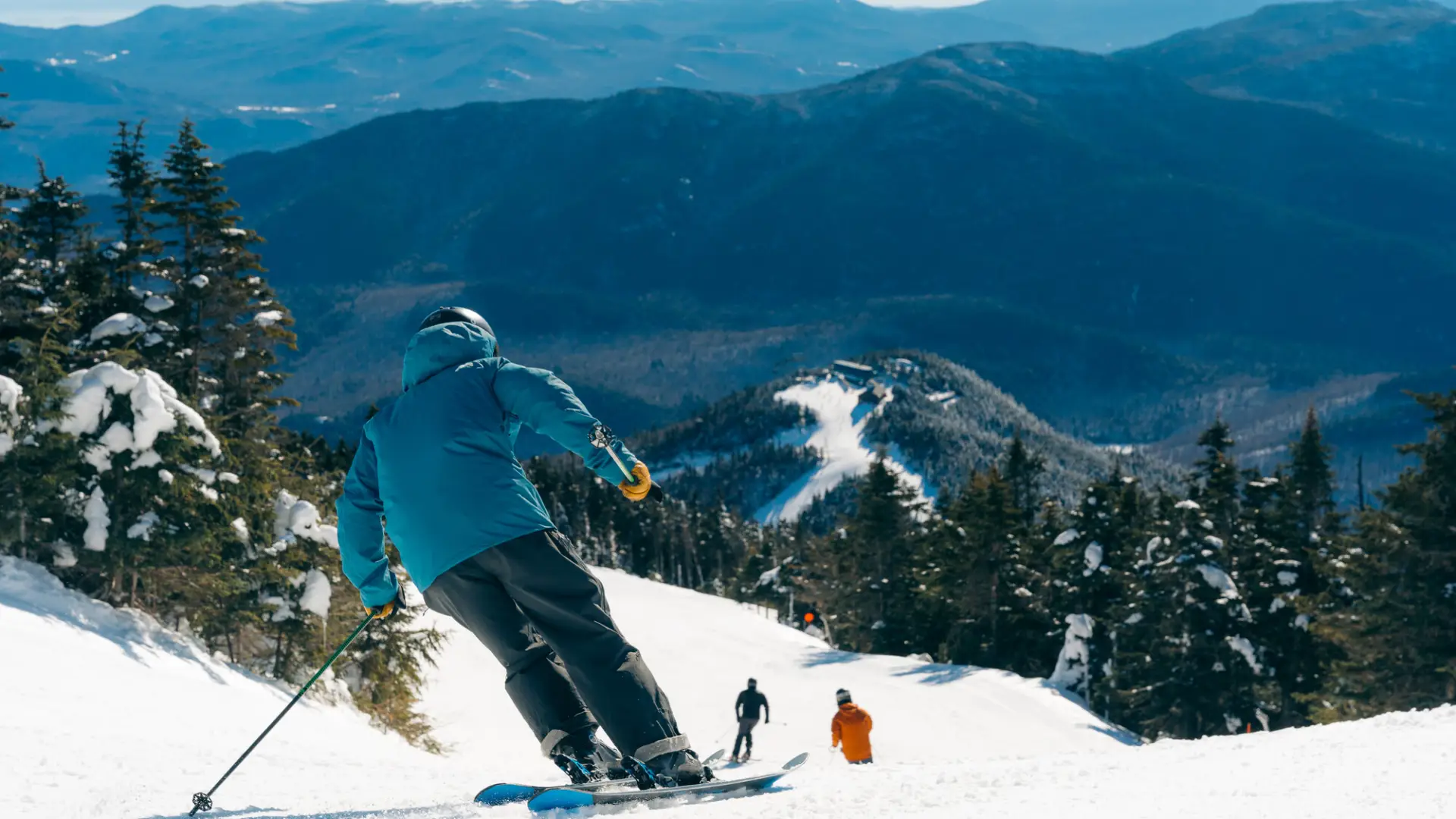 A man skis down a snowy mountain. 