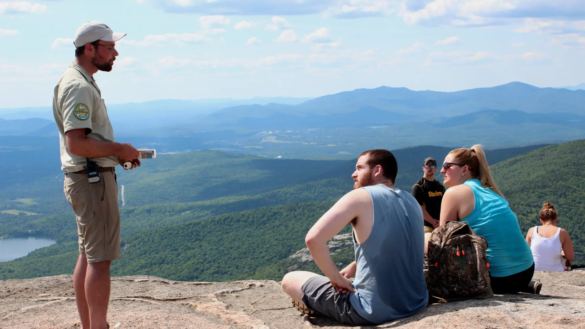 A summit steward educates hikers on the fragile alpine vegetation on Cascade's summit.