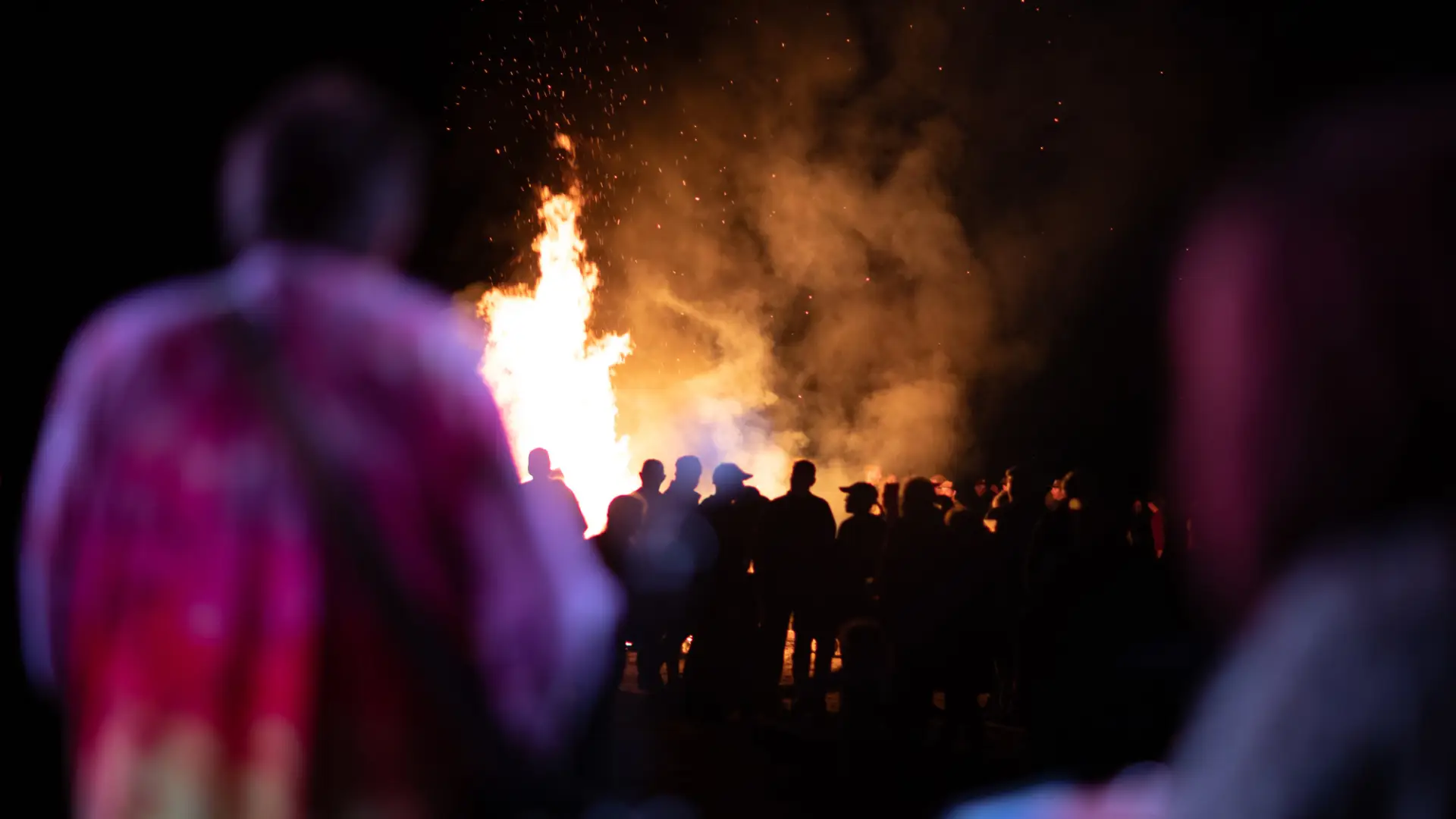 Backed up view of the crowd in front of the bonfire