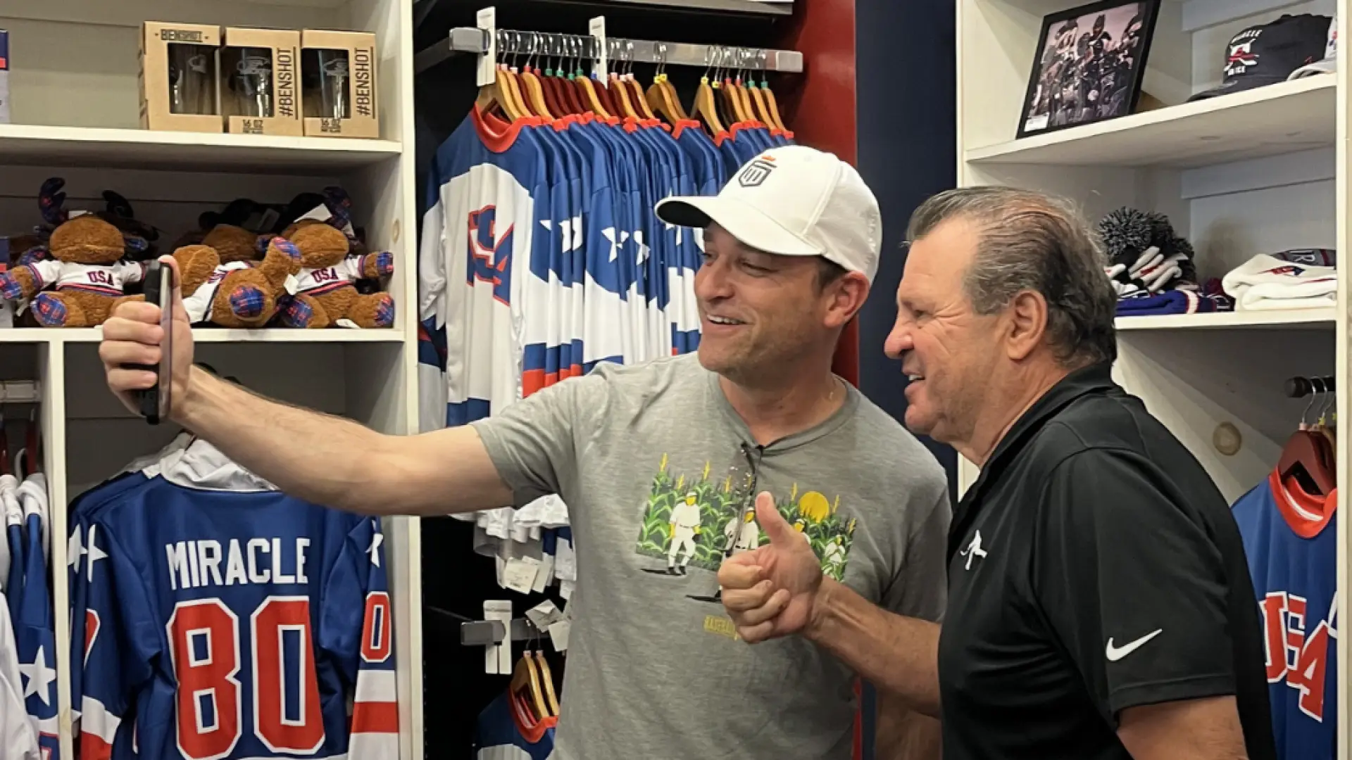 1980 Olympic Gold Medal Men's USA Hockey Team Captain Mike Eruzione poses for selfie in store with fan