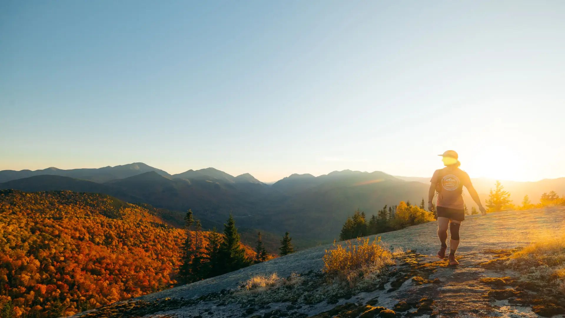 A person walking along a fall summit.