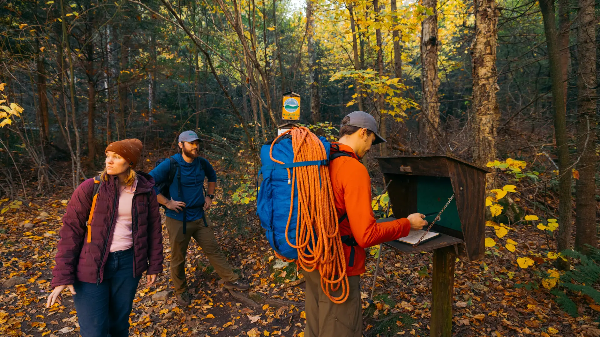 A group of climbers signing in at a trail register