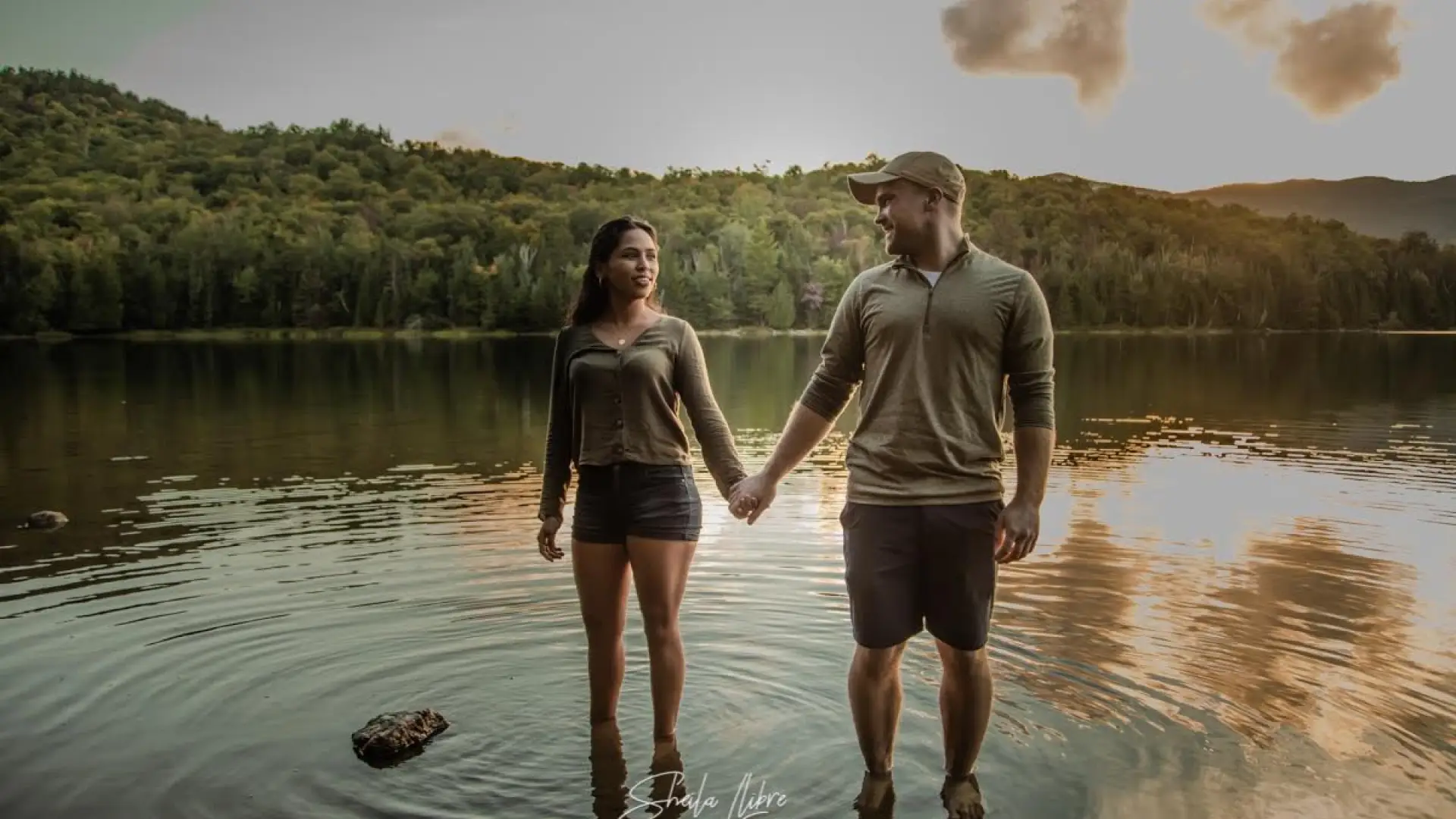 Couple holding hands at waters edge