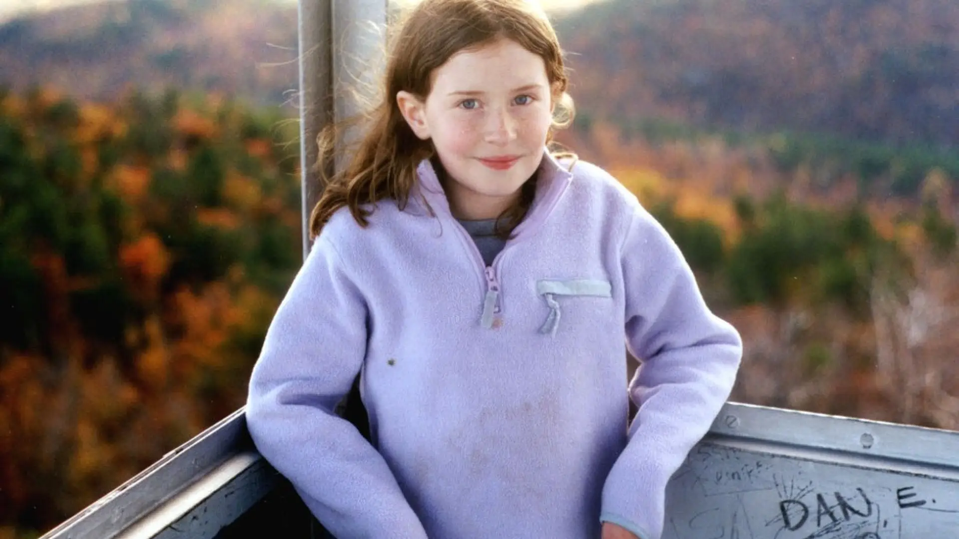 Girl standing in a firetower during Autumn