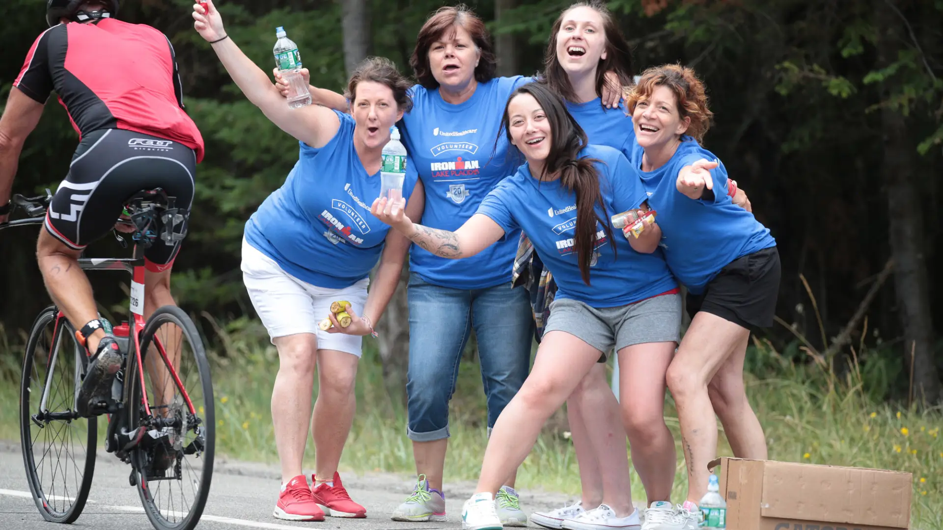 A joyful bunch of volunteers out on course handing out water.