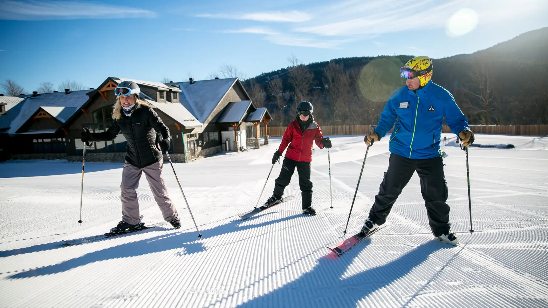 Two people are learning the basics from their ski instructor
