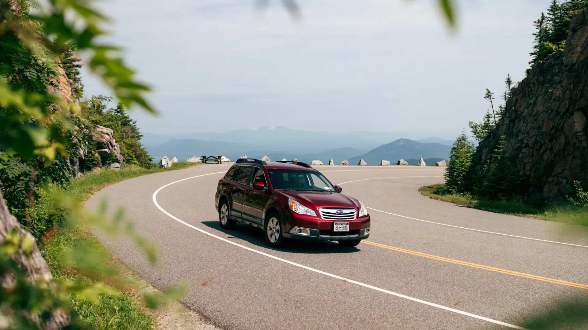 A car drives up a mountain road. 