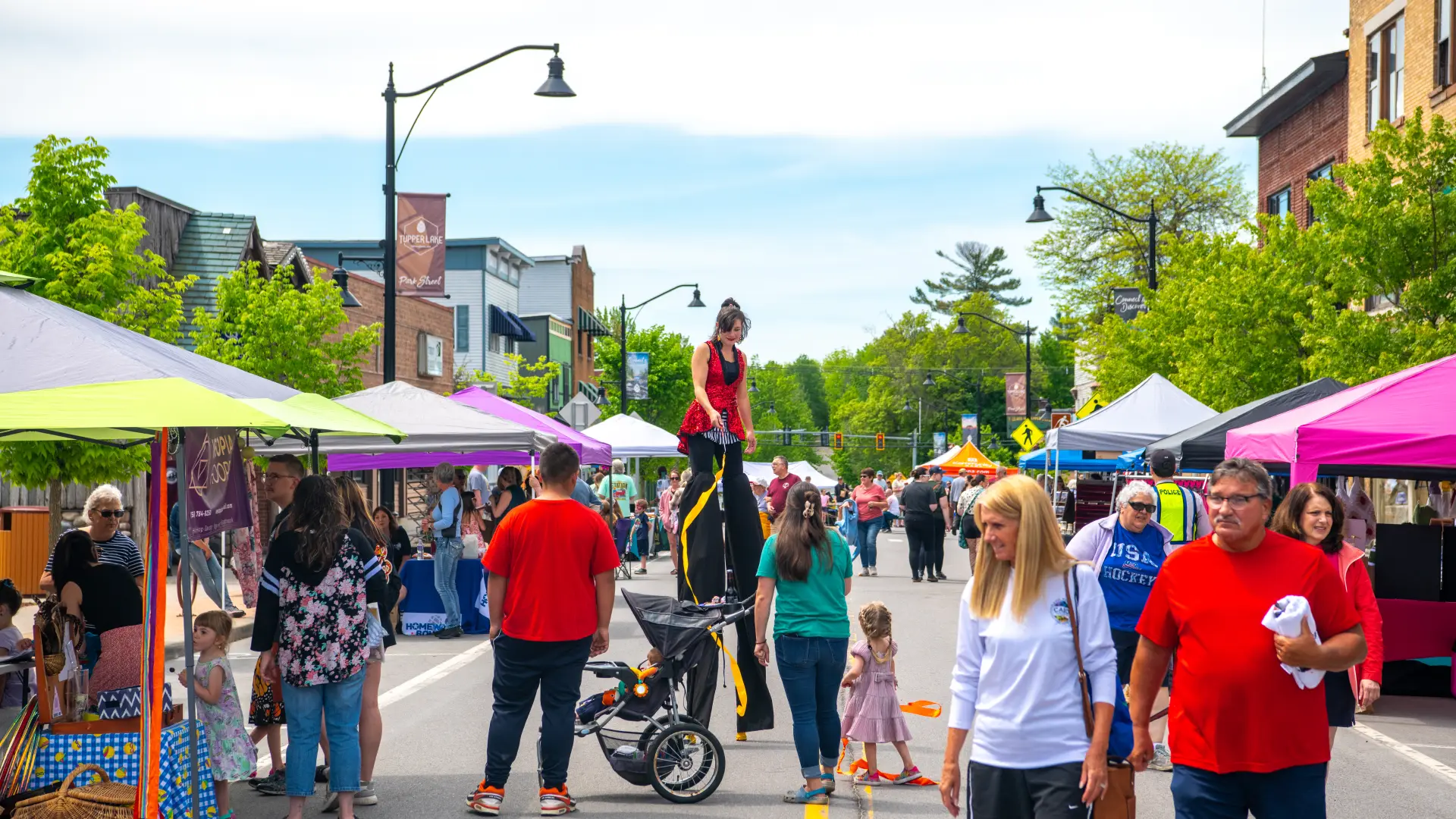 A crowd of people enjoying an event during a sunny day.