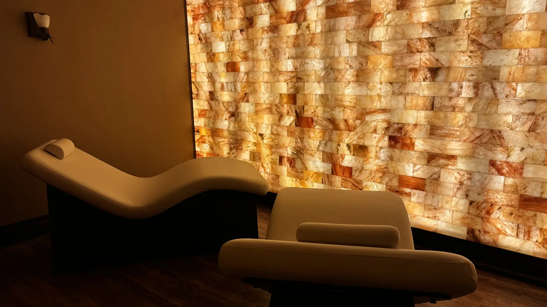Wall of salt blocks iluminated from behind creating the warm glow to make you breathe easier